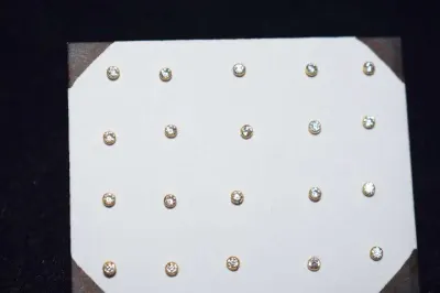 Display box of 12 pairs of 14k gold nose bones by Acha Co., Ltd